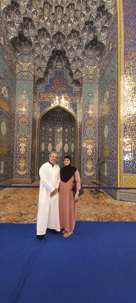 Couple inside Sultan Qaboos Grand Mosque prayer hall Oman