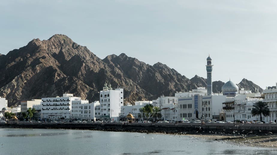 Old Muscat coastal forts and traditional white buildings