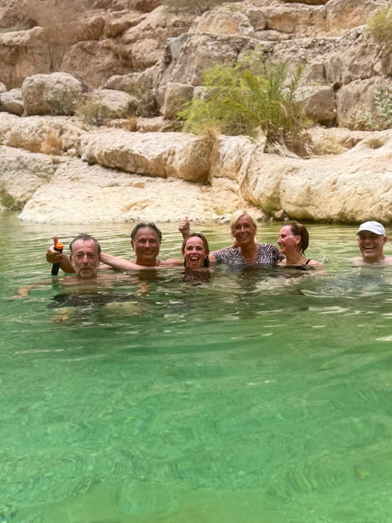 Dutch visitors swimming in Wadi Shab emerald pools Oman