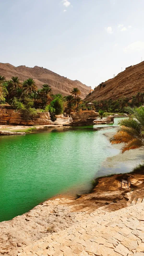 Natural emerald pool surrounded by rock in Oman