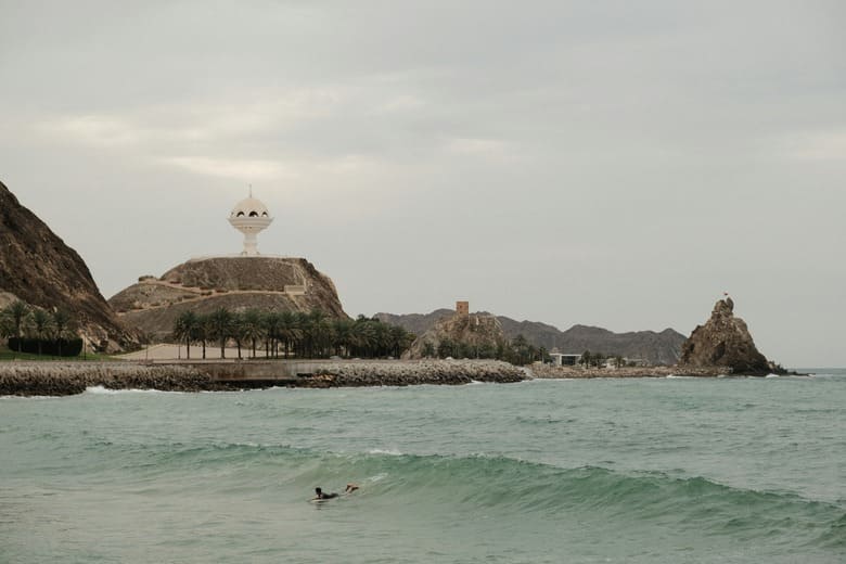 Riyam Park incense burner monument and Muscat coastline — family beach area