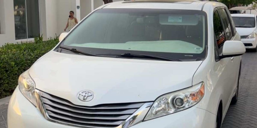 White private tour vehicle ready for Dubai to Oman road transfer