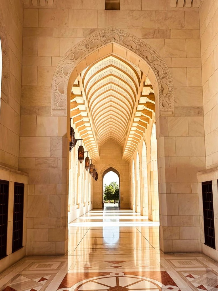 Arched marble corridor walkways inside Sultan Qaboos Grand Mosque Muscat