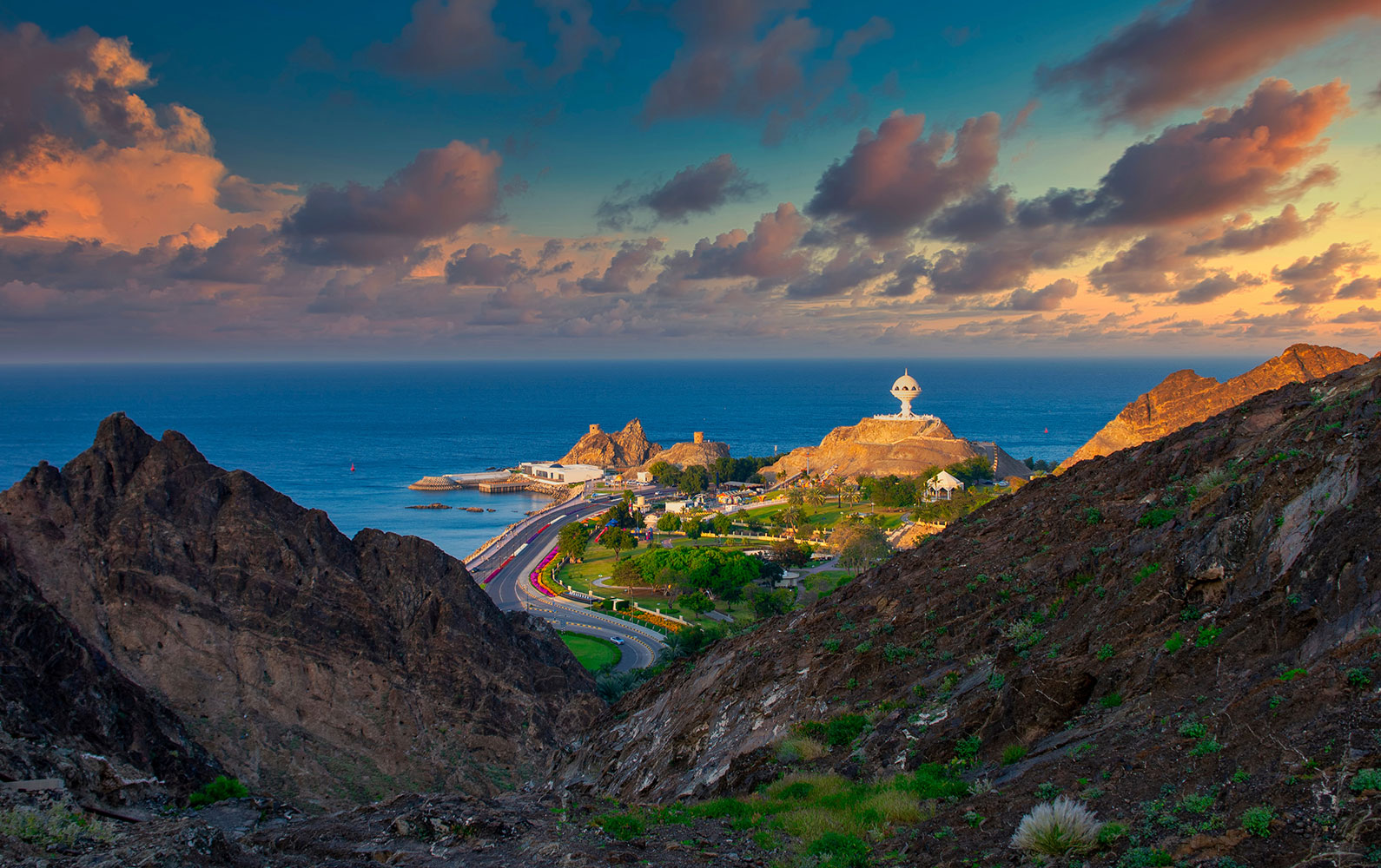 Panoramic view of Muscat city tour featuring Sultan Qaboos Grand Mosque, Mutrah Souq, Royal Opera House, and scenic coastal roads in Oman